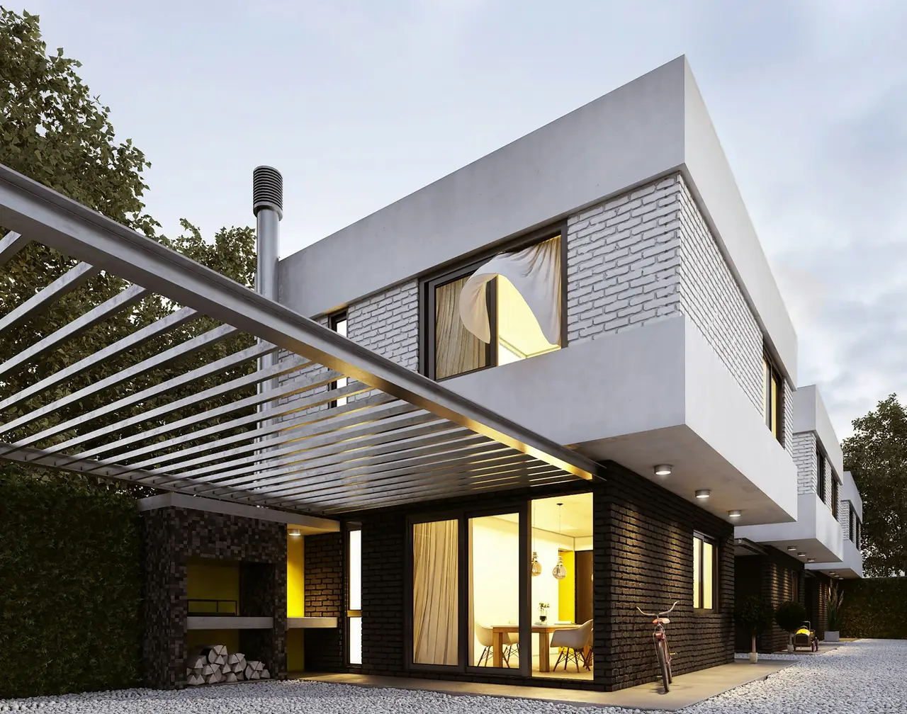 A modern two-storey home lit up at dusk