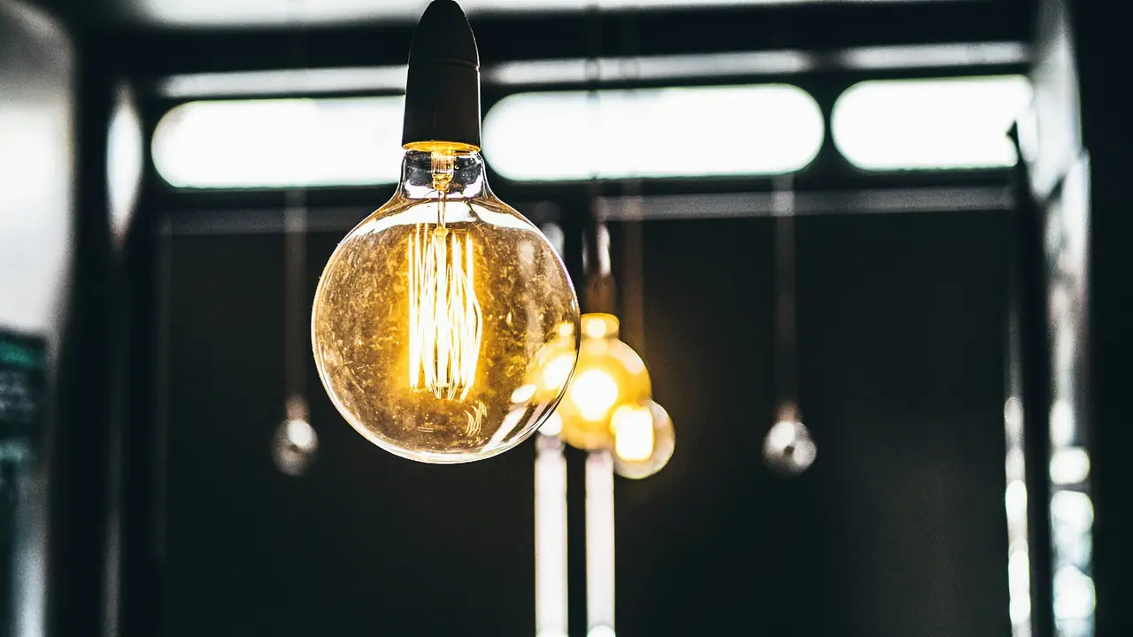A single glowing filament bulb