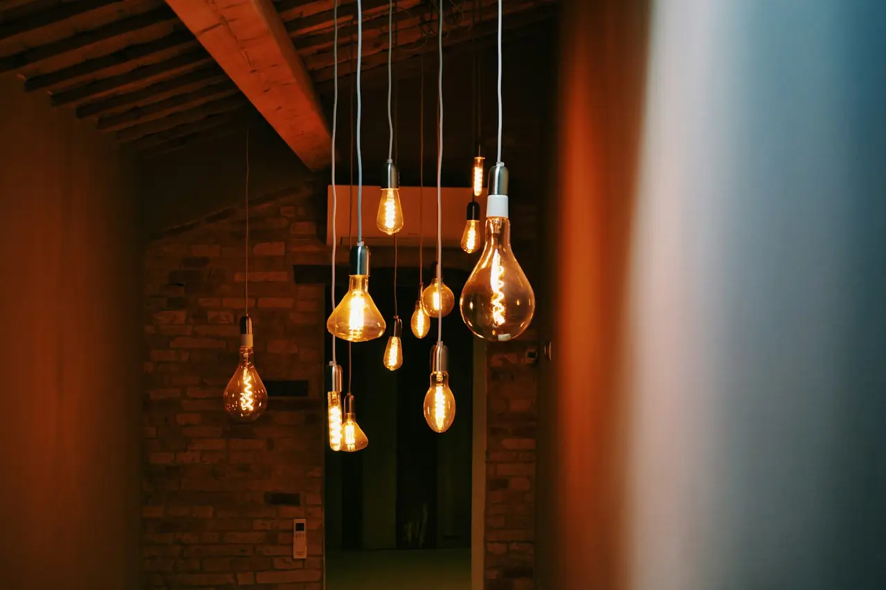 Warm filament pendant lights in a timber-ceilinged room