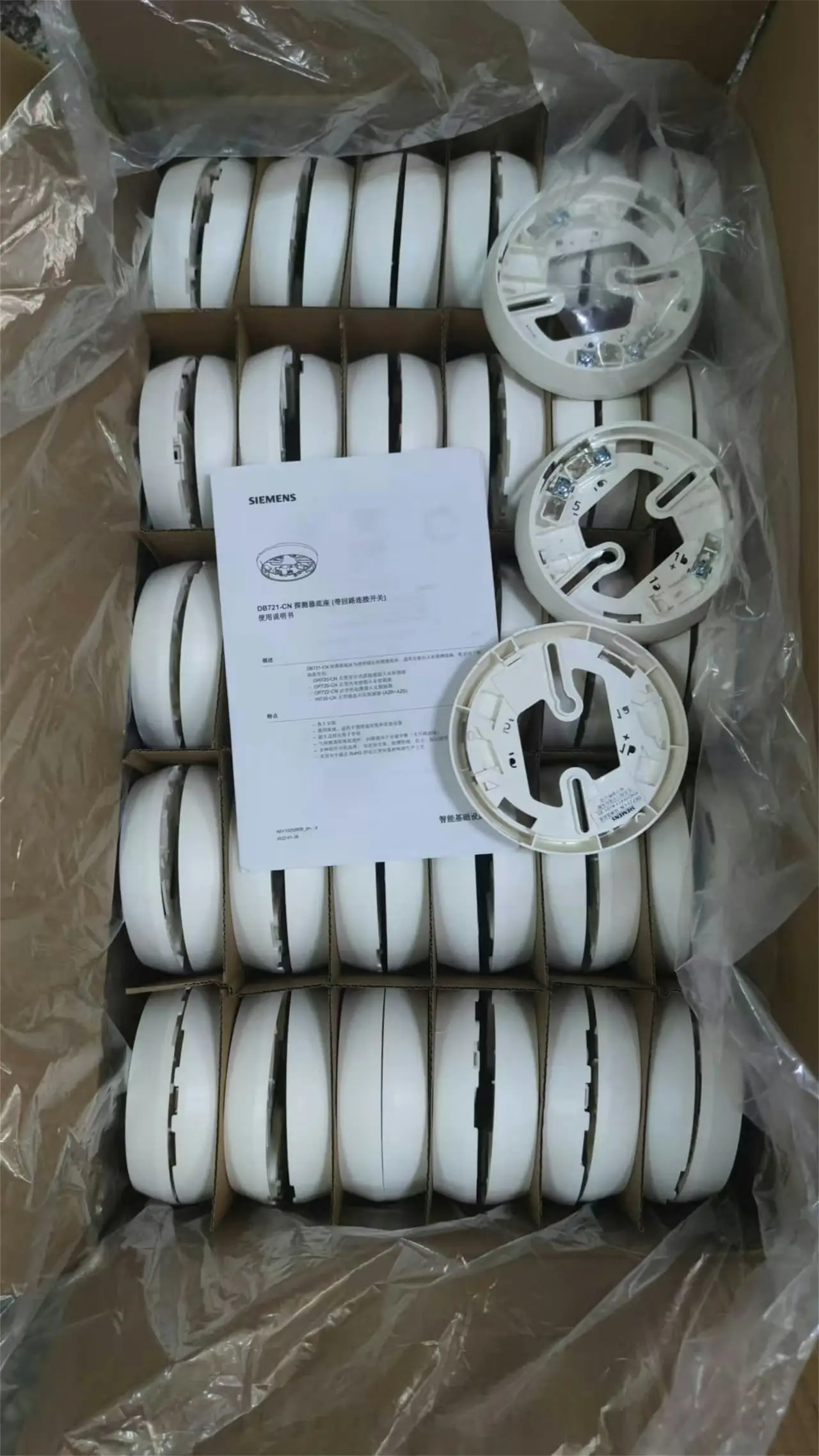 A box of new photoelectric smoke alarms with instructions