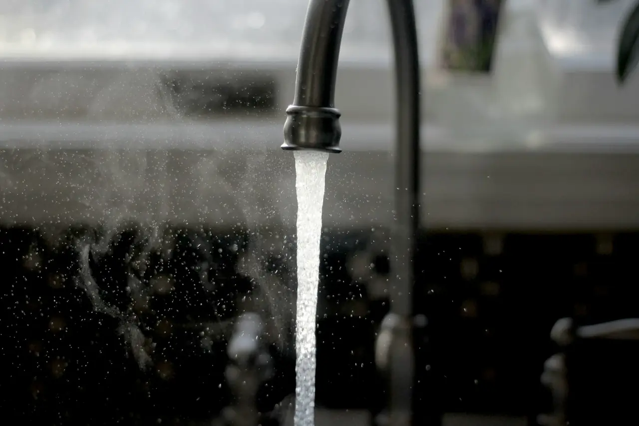 Water running from a black kitchen tap