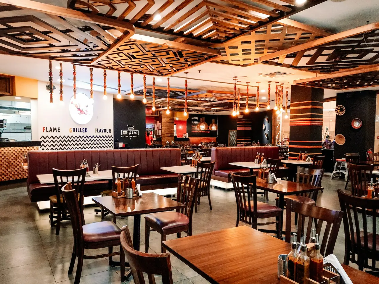 A restaurant interior with a timber lattice ceiling and booth seating
