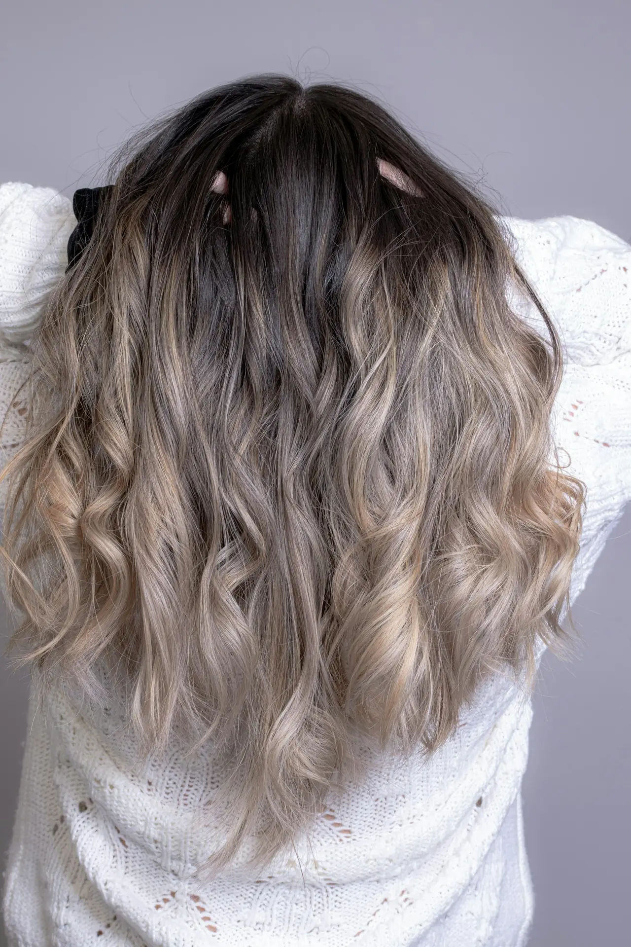 Long, wavy hair with soft blonde balayage through the ends